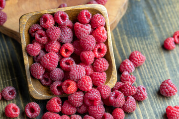 Ripe raspberries on a wooden board