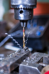 Fitter Man Using Metal Drilling Machine for Making Holes In Metal Detail With Long Drill in Workshop.