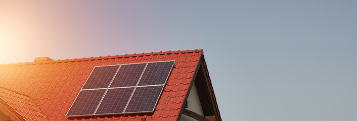 Solar panels on the roof of the modern house. Residential house cottage with blue shiny solar photo...