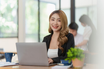 Smiling Asian Accountant person analyze financial report and studies annual figures, analyzes profits