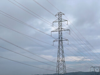 Power transmission line. Industrial background. Power pylons of an overhead line