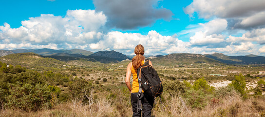 Hiker woman enjoying panoramic view Cevennes guarrigue landscape (Occitanie in France)