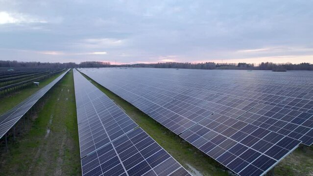 Drone flight over solar array on solar farm, PV photovoltaic panels