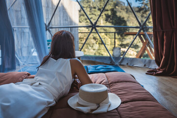 Travel woman relax inside a luxury camping dome tent © Peera