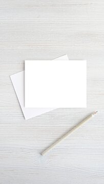 Blank greeting card, postcard, invitation, document mockup, pencil and envelope, minimal style, vertical image for social media story template.