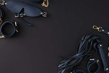 Experience ultimate pleasure with BDSM playthings. Top view shot of handcuffs, dark mask, leather...