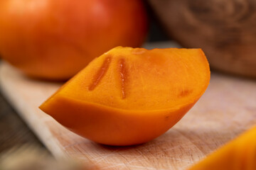 Sliced ripe orange pitted persimmon