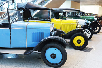 Bright retro cars at the exhibition in the pavilion