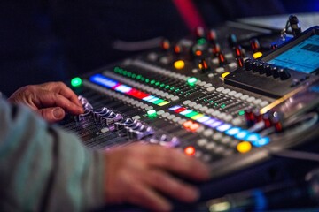 Fototapeta na wymiar Mastering the Sound: Close-Up of Controlling a Digital Live Mixing Sound Console in 4K Resolution