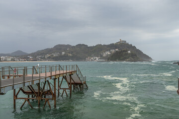 Stormy ocean and dramatic cloudy weather in San Sebastian port,