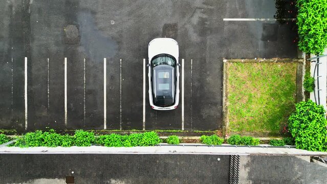 Top down video car parking alone. Smart Cars Aerial Camera. Car reversing in a parking space.