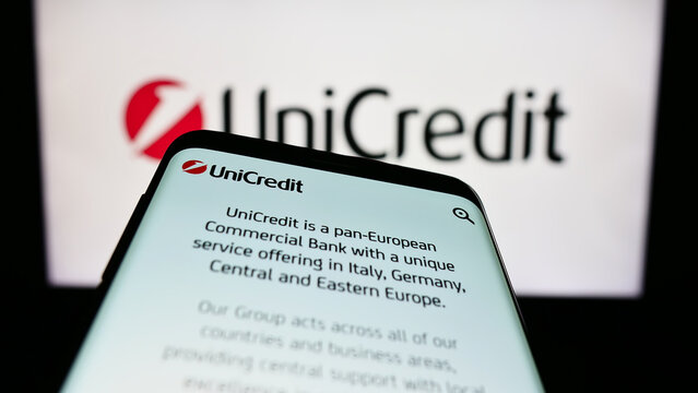 Stuttgart, Germany - 06-17-2023: Mobile phone with webpage of Italian financial company UniCredit S.p.A. on screen in front of business logo. Focus on top-left of phone display.