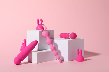Composition of pink sex toys with cubes on a pink background - obrazy, fototapety, plakaty