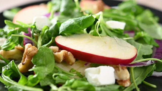 Autumn salad with apples and walnuts rotating footage.
