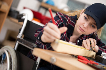 a disable woman carpenter in wheelchair