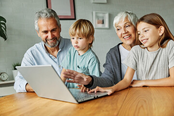 child laptop home family grandparent computer together grandmother technology online adult girl...