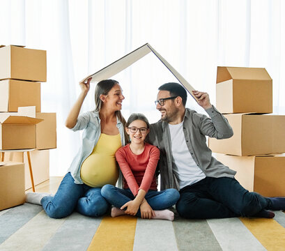 child family box home house moving happy apartment pregnant mother father daughter relocation new property parent pregnancy roof hand mortgage insurance protection built