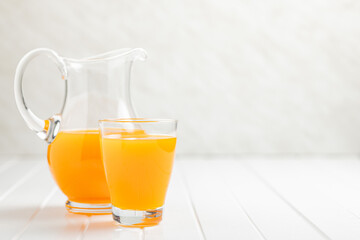 A glass of fruit juice. Orange  juice on white table.