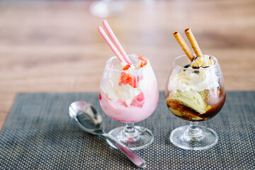 Ice cream in colorful wine glasses looks delicious on the dining table.