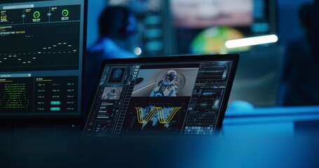Successful space rocket launch for crewed mission displayed on digital tablet and PC monitor. Team of flight control employees monitor space mission on computer and big screen in command center.