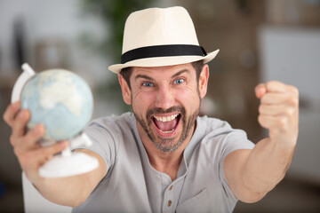 happy man holding a world globe