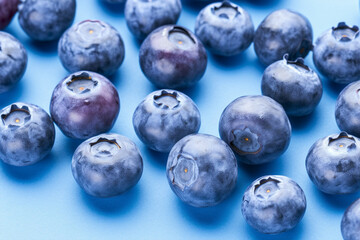 Blueberry fruits on blue background.