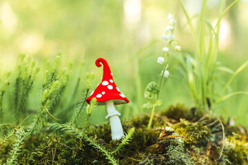 Fabulous plasticine fly agaric in the forest.