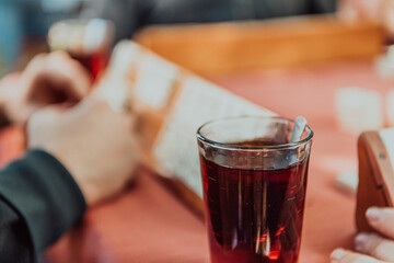 A group of men drink traditional Turkish tea and play a Turkish game called Okey