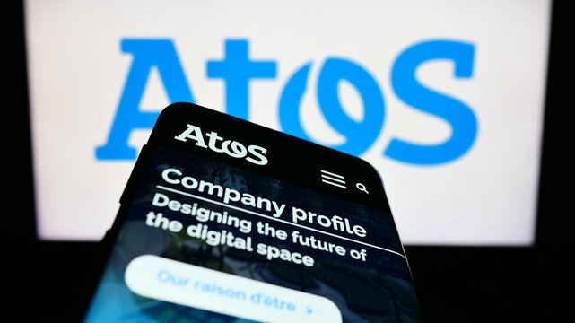 Stuttgart, Germany - 06-17-2023: Mobile phone with webpage of French information technology company Atos SE on screen in front of logo. Focus on top-left of phone display.