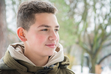 A boy is standing in the spring  park.