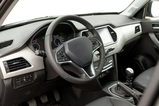 studio photo of car inside driver seat. Interior of prestige modern car. Front seat with display, steering wheel and dashboard