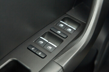 Obraz premium Car interior on the doors inside car door handle with power window control unit