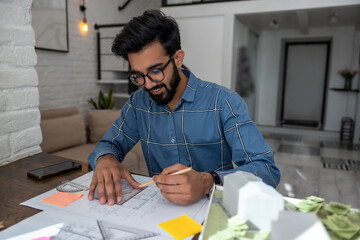 Young bearded man looking busy dealing with the project