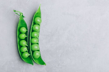 Pea. Green peas pod on gray stone background, top view