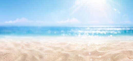 Fototapeta na wymiar Sand With Blue Sea - Beach Summer Defocused Background With Glittering Of Sunlights