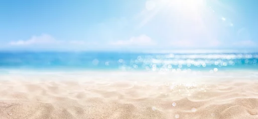 Foto auf Glas Sand With Blue Sea - Beach Summer Defocused Background With Glittering Of Sunlights © Romolo Tavani