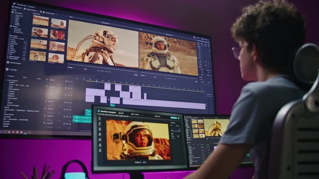 Young editor, video maker edits movie with astronauts, works at home office. Film footage and software interface with tools and sound tracks on PC and big digital screen. Concept of post production.