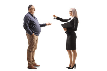Businesswoman giving car keys to a mature man