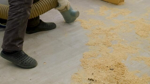 Vacuum cleaner sawdust in furniture production. Selective focus.