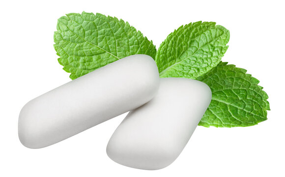 Two chewing gum pieces with fresh mint leaves, cut out