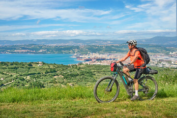 Obraz premium nice active senior woman on a mountain bike tour at the Slovenian Mediterranen cost above Koper at Capodistria
