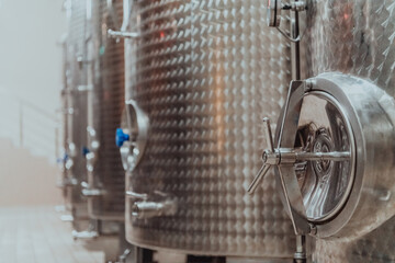 Modern wine distillery and brewery with brew kettles pipes and stainless steel tanks