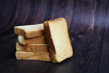 Tea Time Snack. Healthy Wheat rusk served with Indian hot masala tea and milk jug over black background. also known as Mumbai cutting chai. with Copy space. Crunchy rusk or toast.