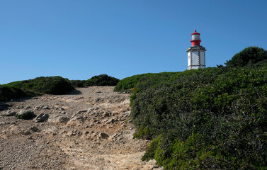 Fototapeta na wymiar Lighthouse Cabo Espichel at the coast of Portugal on a sunny day