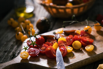 Various selection of tomatoes, brown, yellow, red and green. Sorted and arranged for baking.