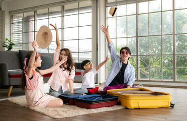 Fototapeta premium Packing for a weekend trip with the father, mother, son, and daughter