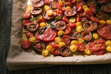 Various selection of tomatoes, brown, yellow, red and green. Sorted and arranged for baking.