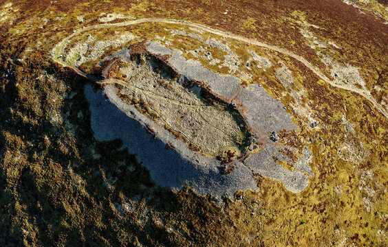 Tap o&rsquo; Noth prehistoric hillfort Grampian, Scotland. Massive vitrified wall of Neolithic core. Outer rampart encloses large early Medieval settlement