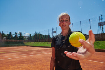 Before her training, the tennis player joyfully playing with a tennis ball, radiating enthusiasm...