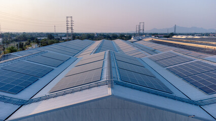 Future green energy and sustainable electricity resource concept. Outdoor focus on solar panels on rooftops or photovoltaics of factories by drone. Industrial roof with solar cell grid with blue tone.